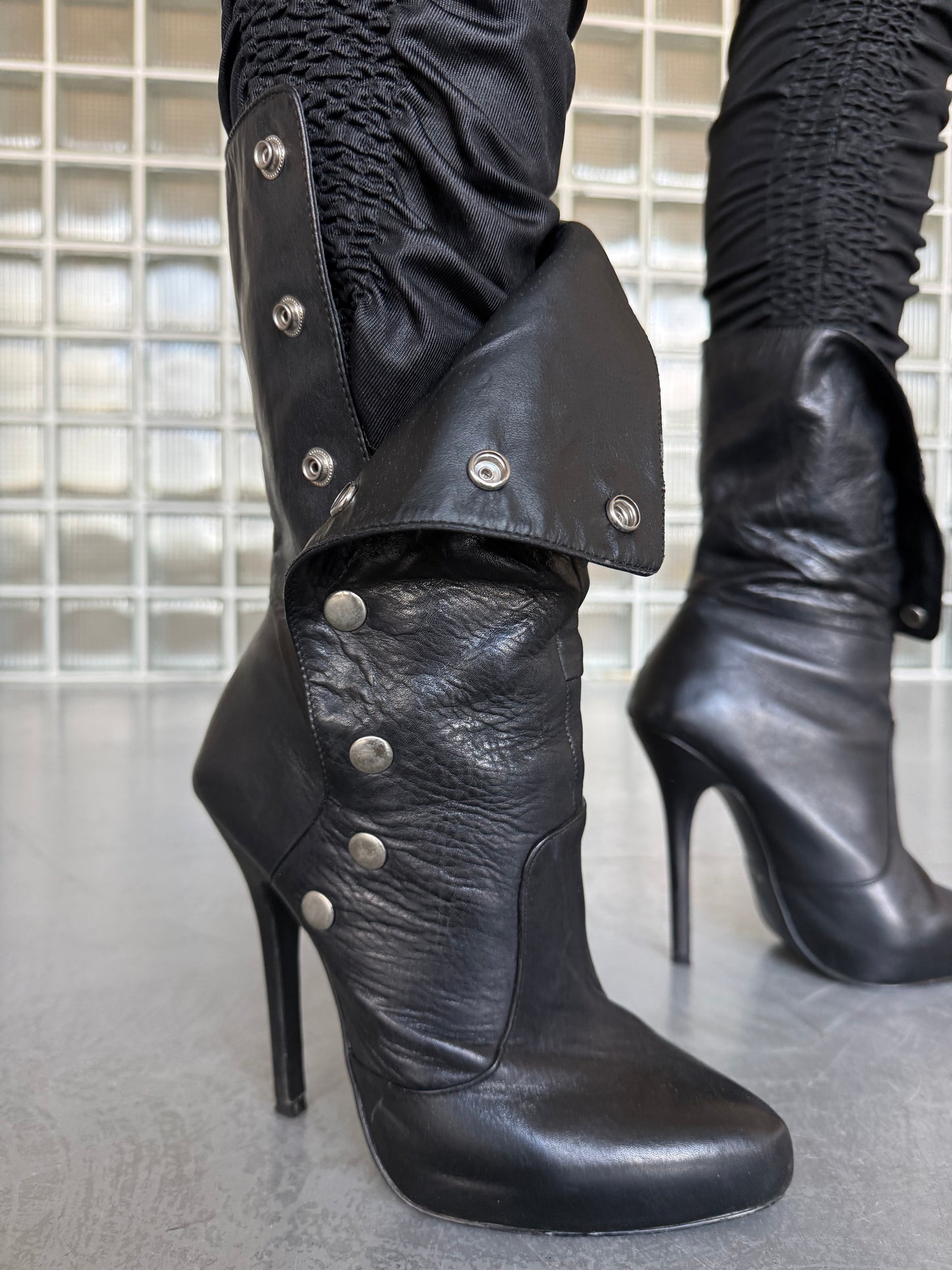 Vintage black leather heeled boots with metal button detail