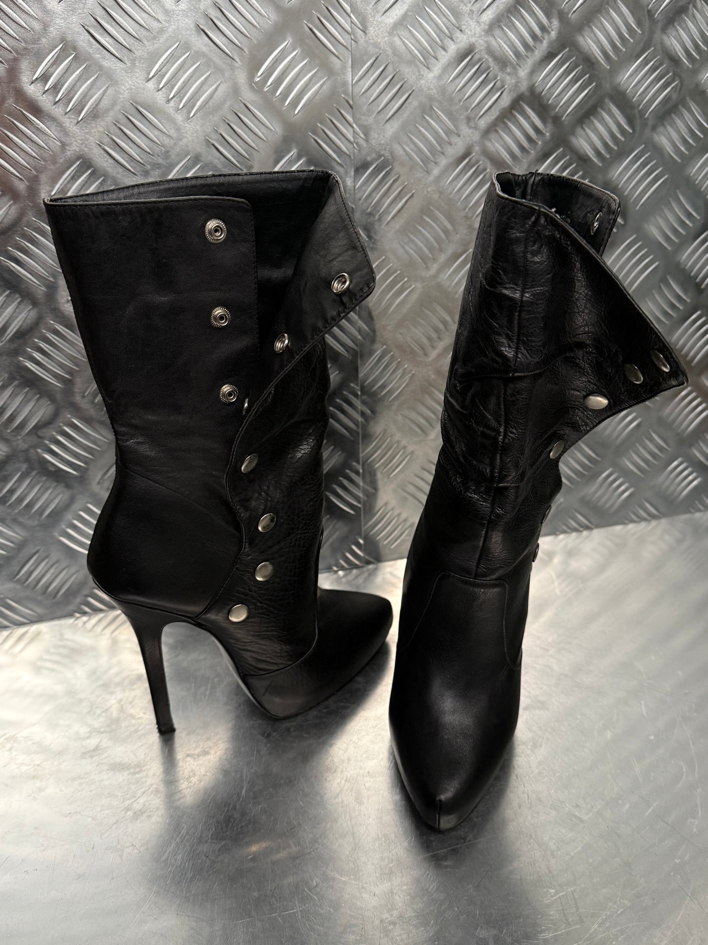 Vintage black leather heeled boots with metal button detail