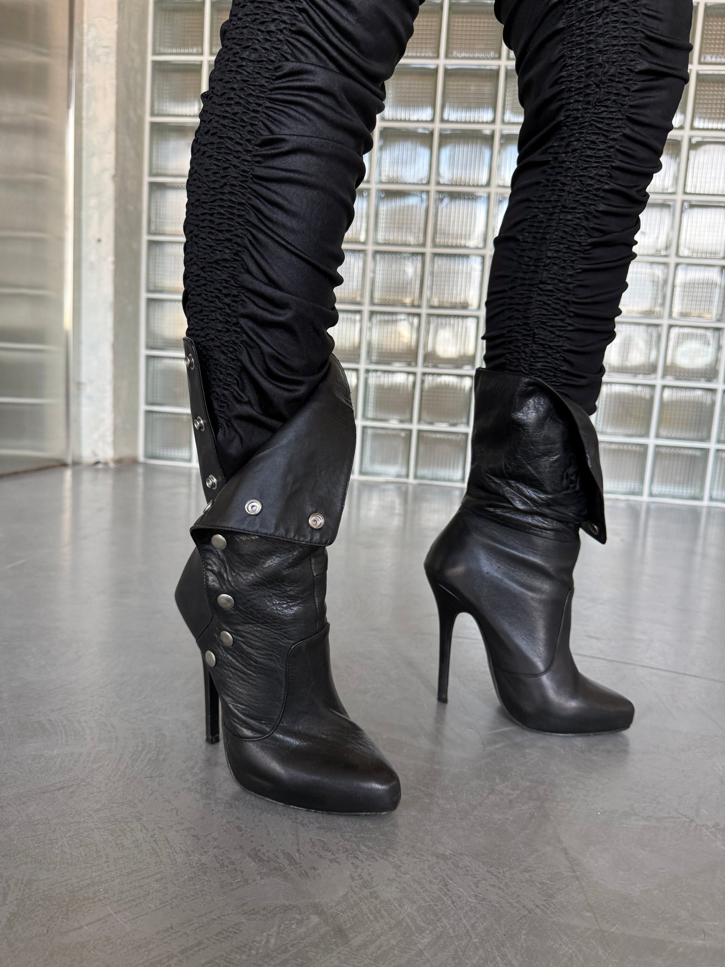 Vintage black leather heeled boots with metal button detail
