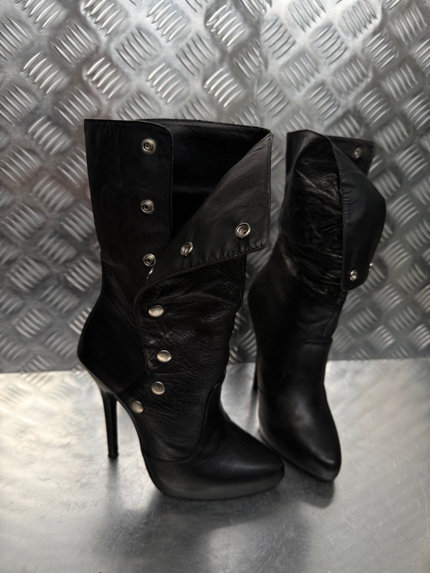 Vintage black leather heeled boots with metal button detail