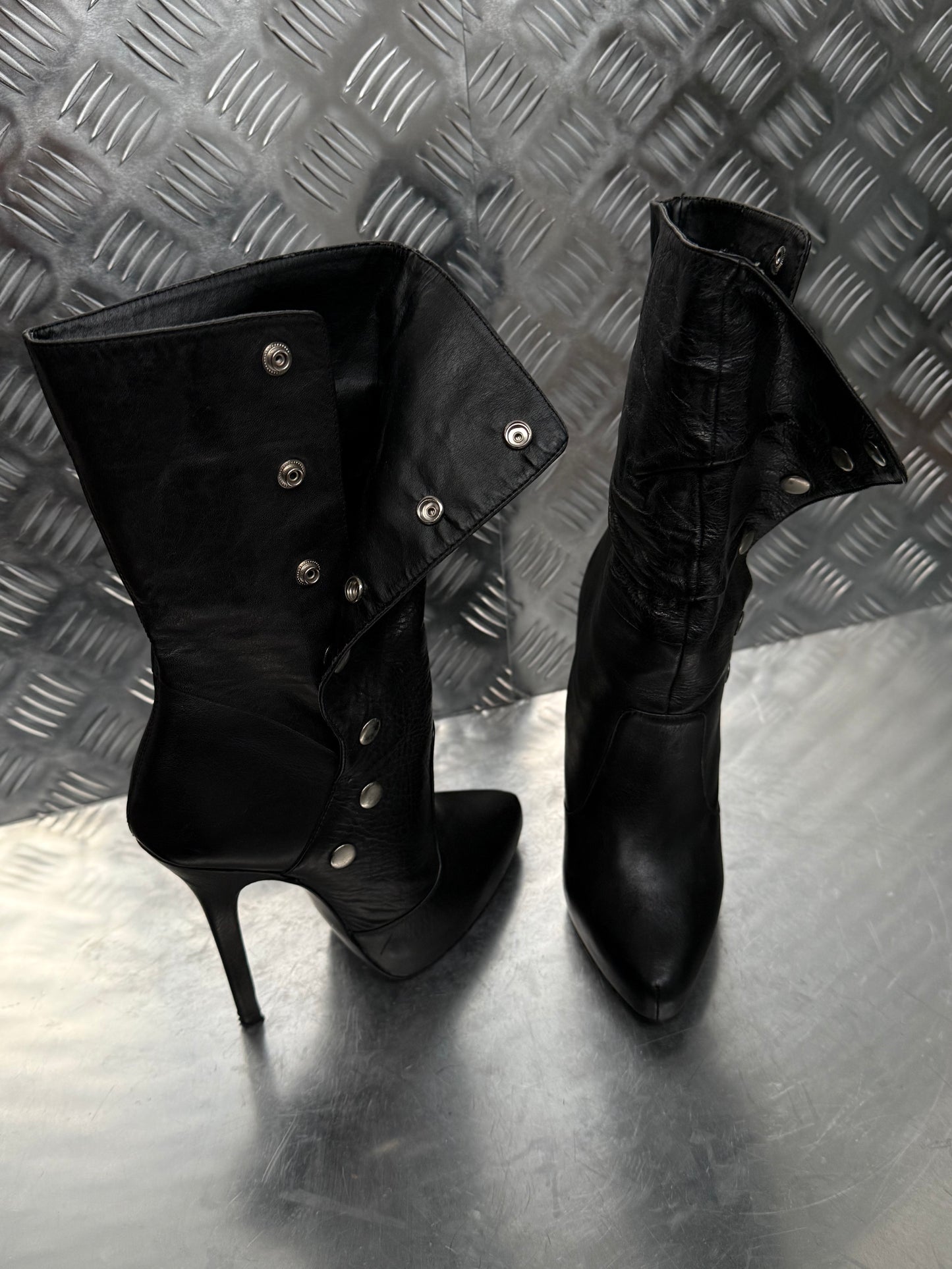 Vintage black leather heeled boots with metal button detail