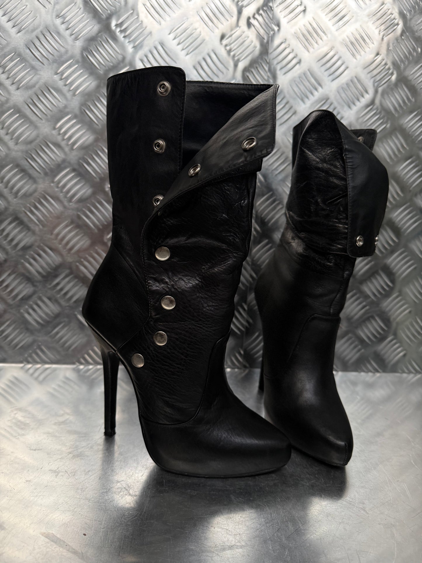 Vintage black leather heeled boots with metal button detail