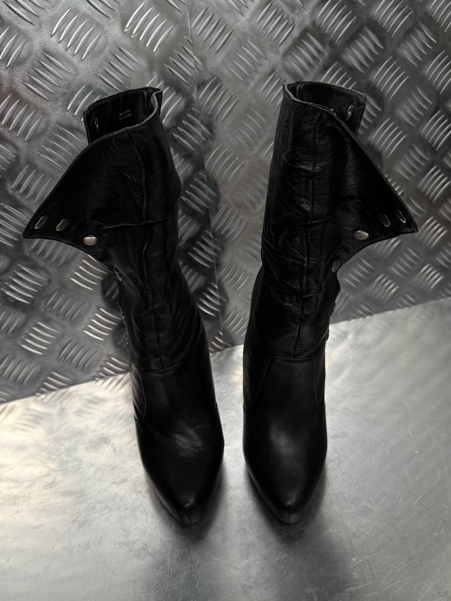 Vintage black leather heeled boots with metal button detail