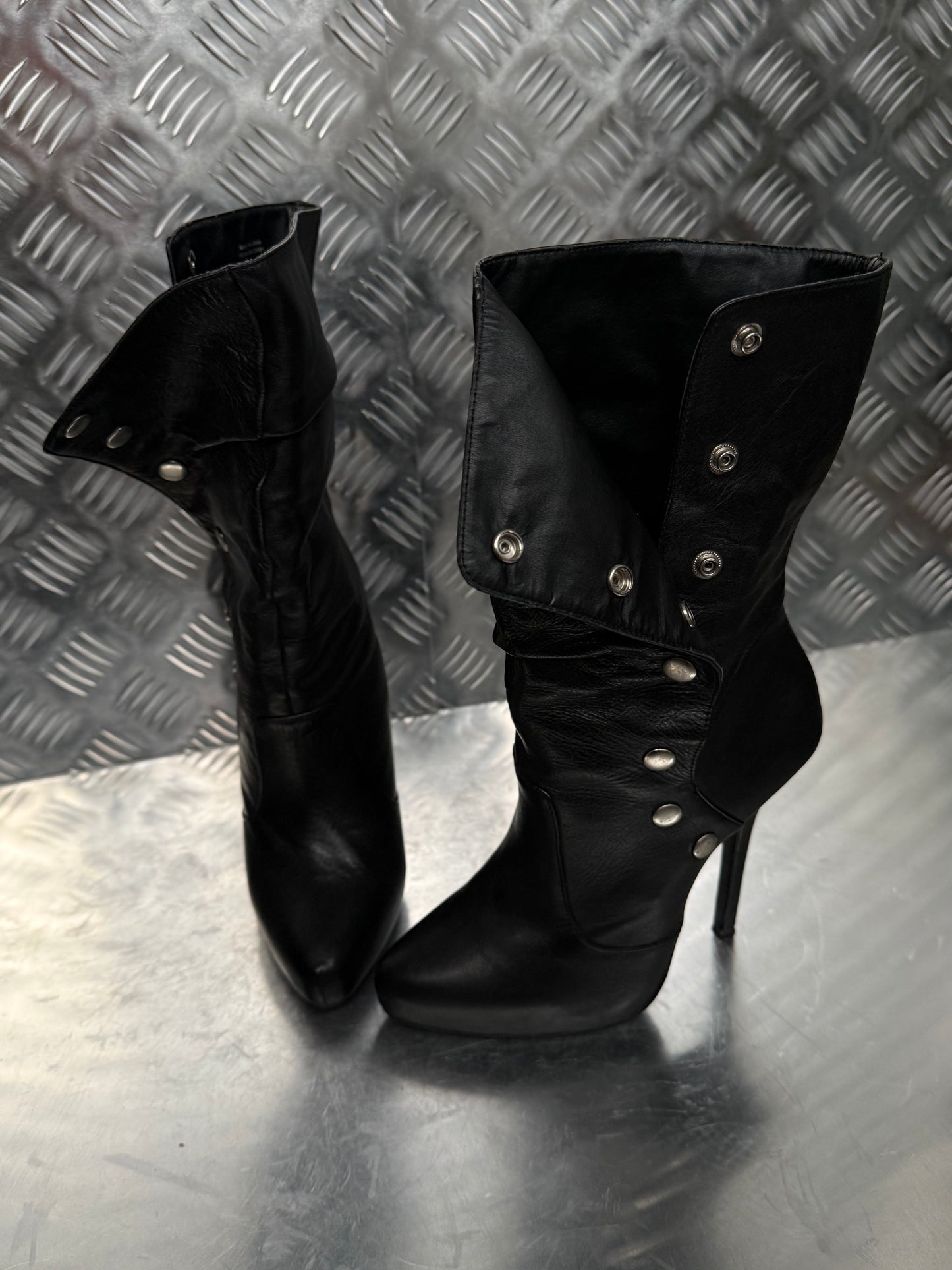 Vintage black leather heeled boots with metal button detail