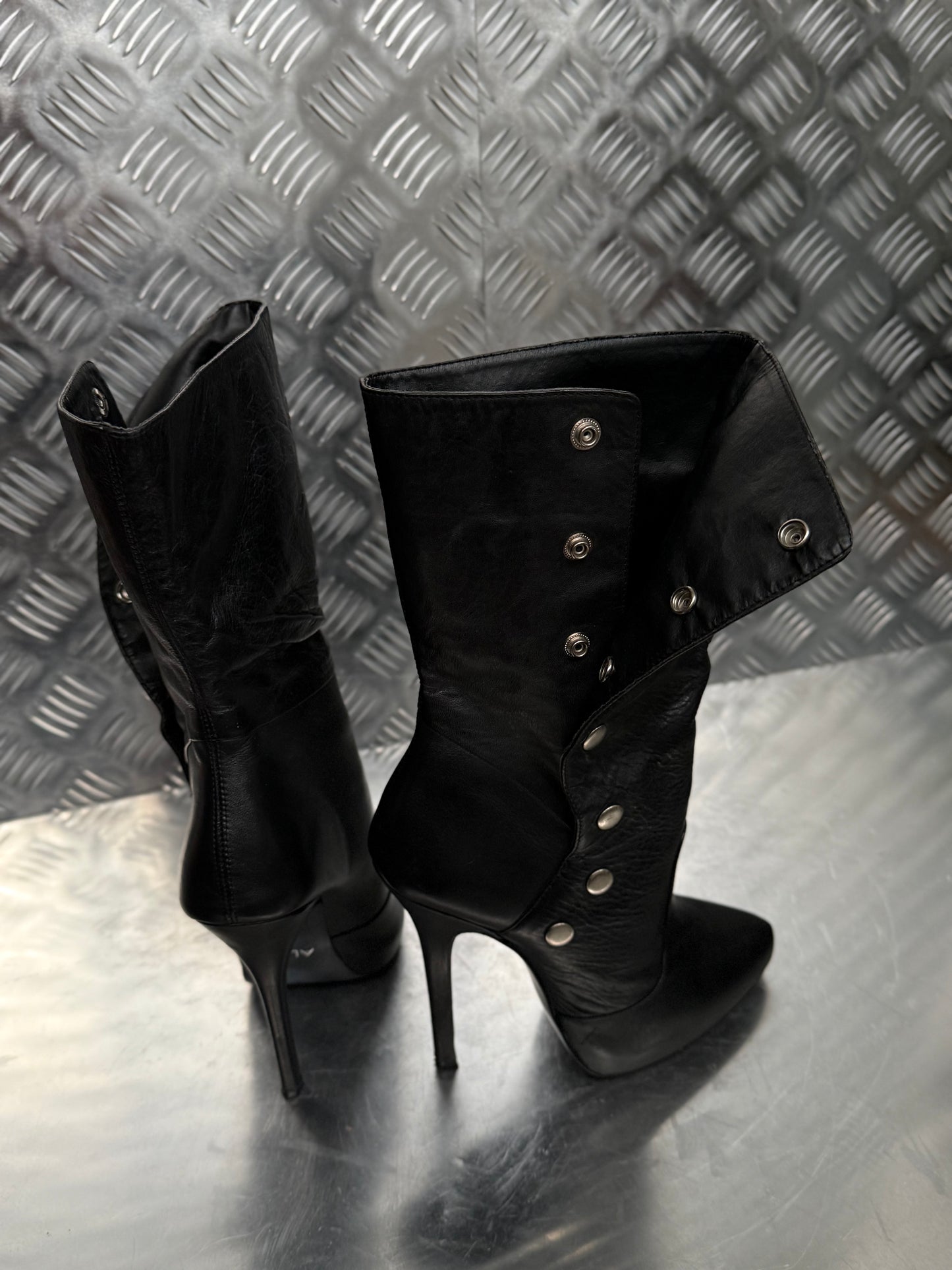 Vintage black leather heeled boots with metal button detail