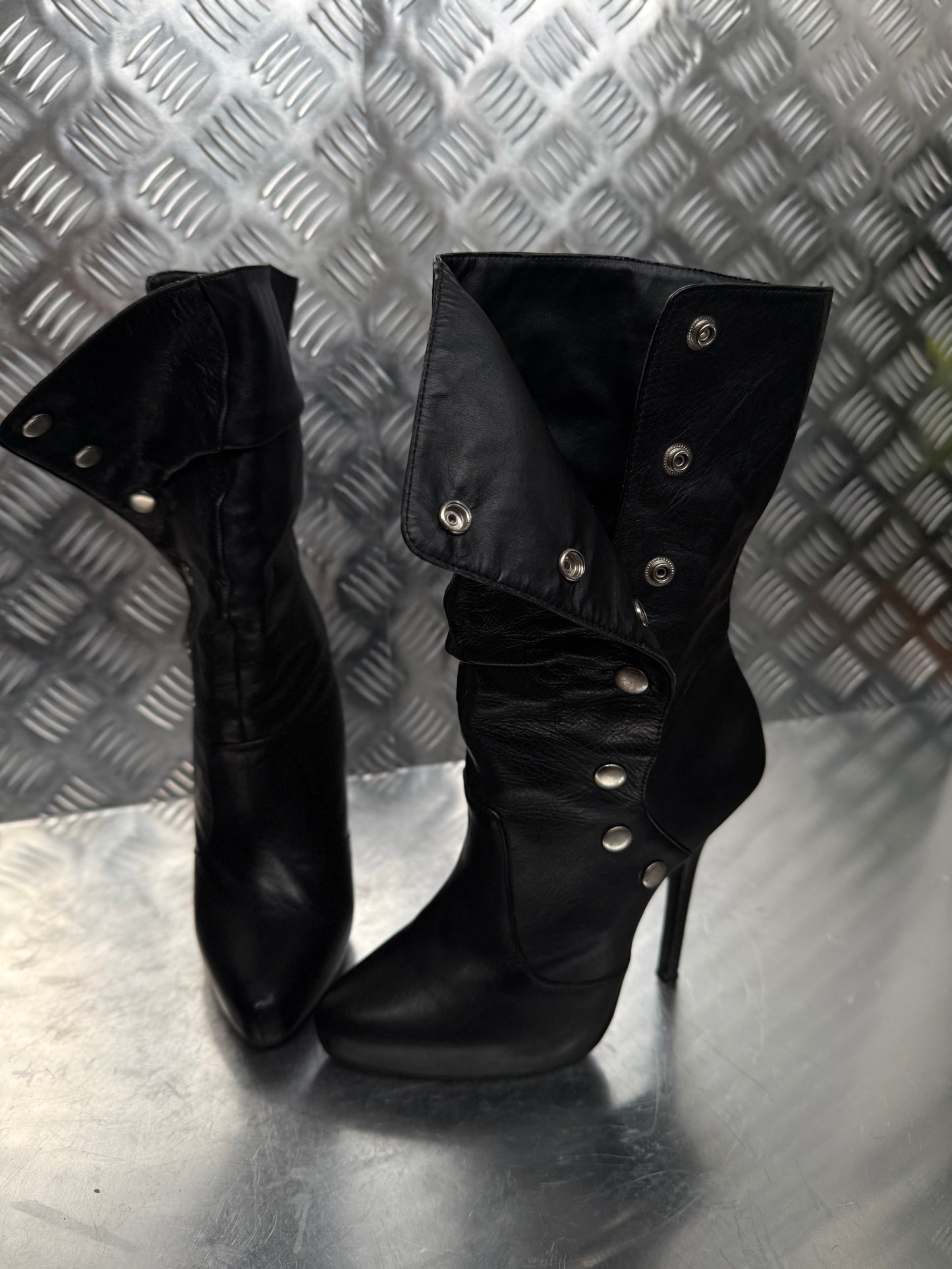 Vintage black leather heeled boots with metal button detail
