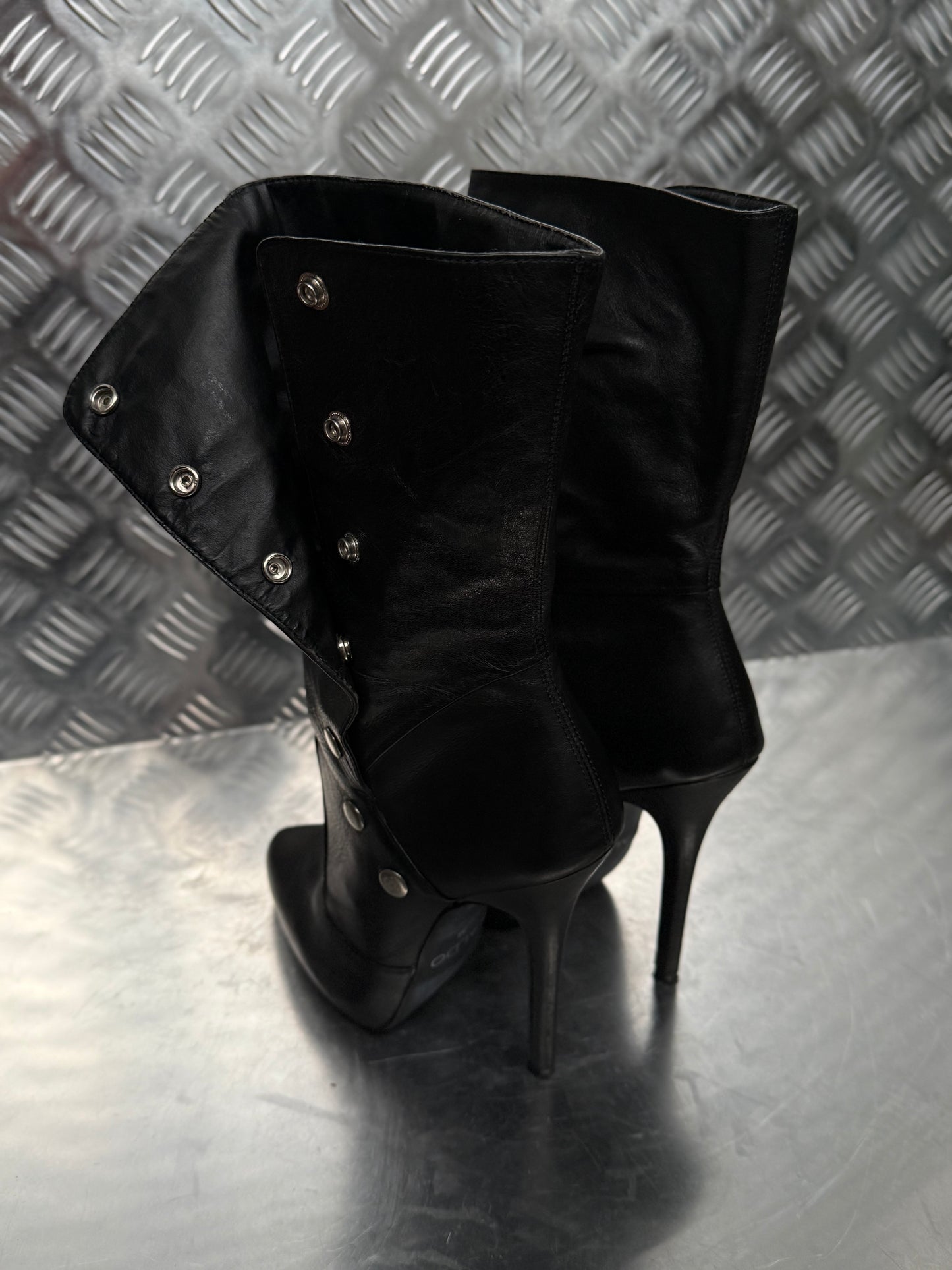 Vintage black leather heeled boots with metal button detail