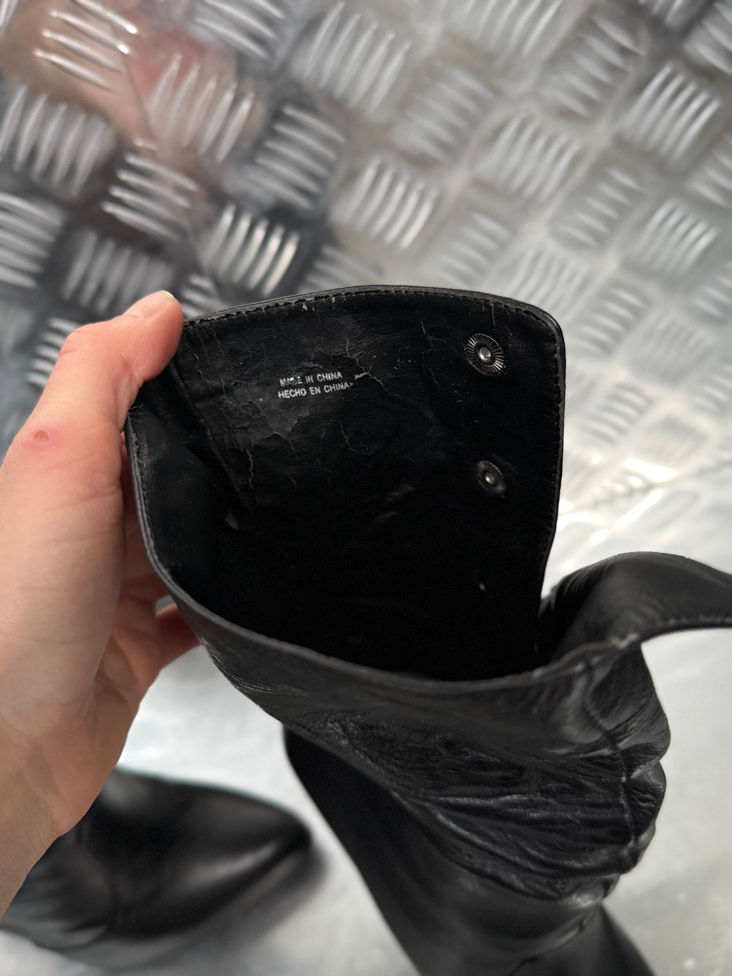 Vintage black leather heeled boots with metal button detail