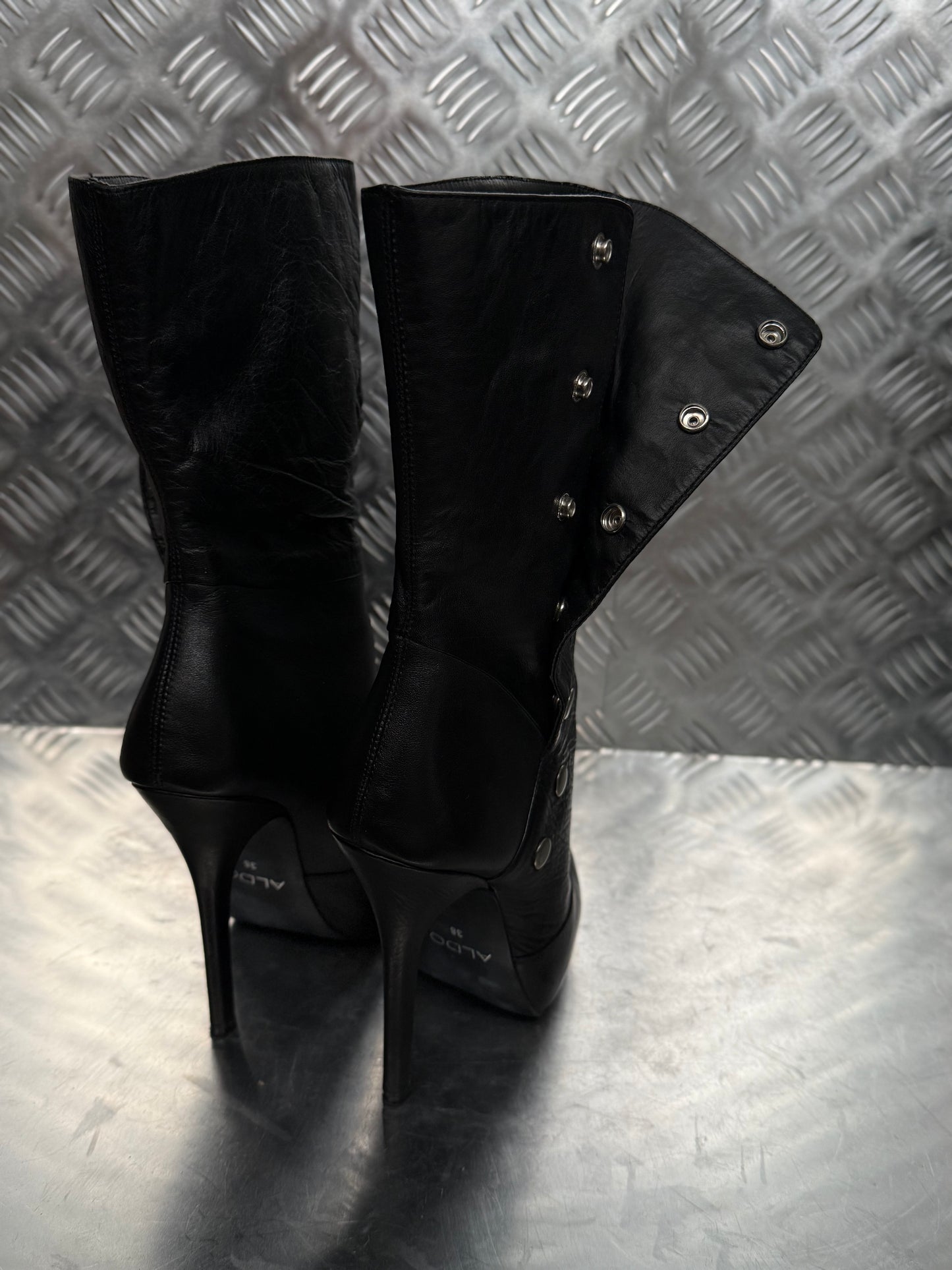 Vintage black leather heeled boots with metal button detail