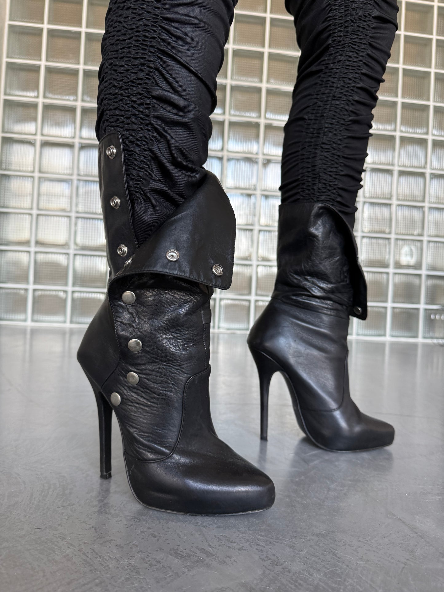 Vintage black leather heeled boots with metal button detail
